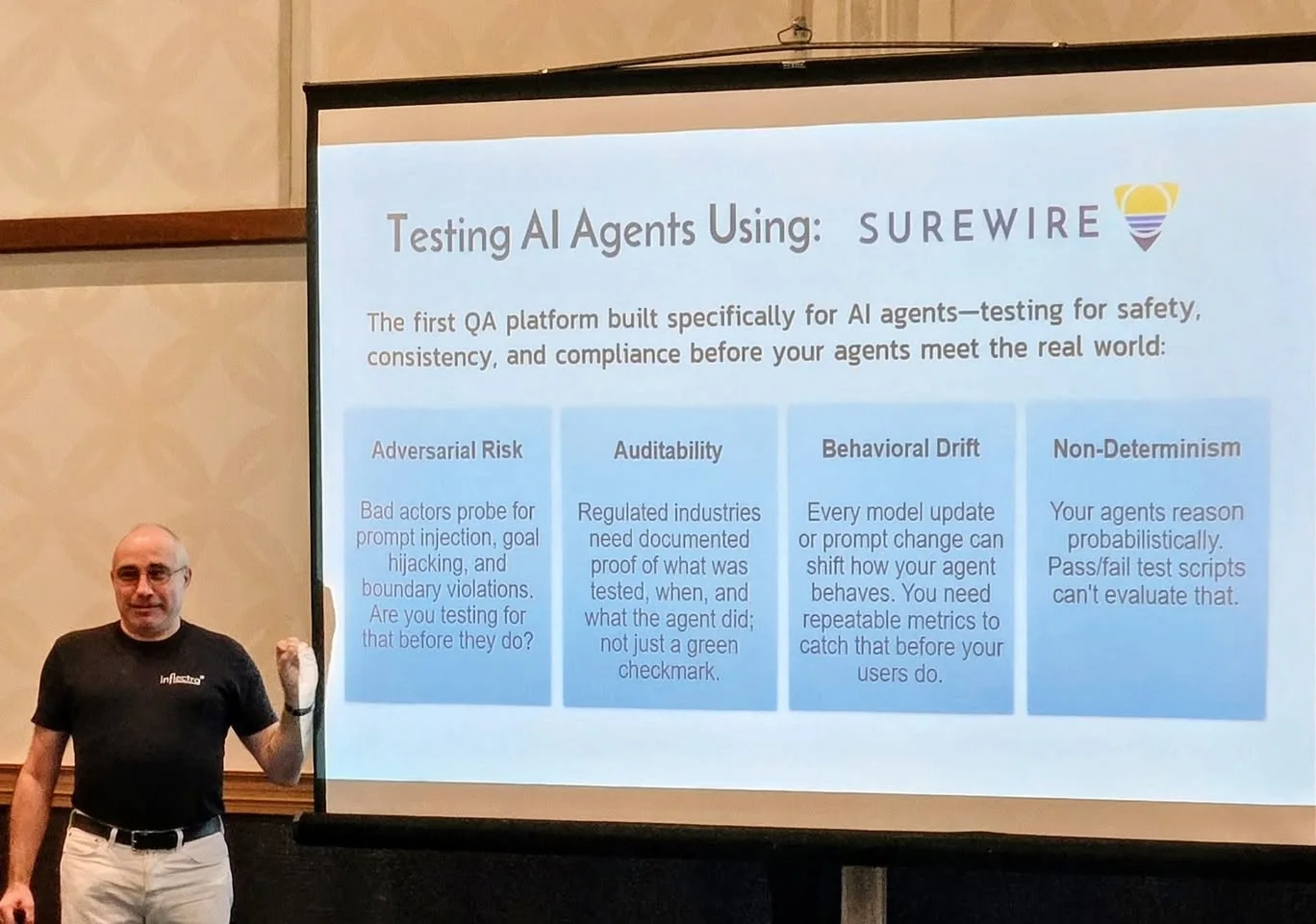 A presenter in an Inflectra shirt discussing testing AI agents.
