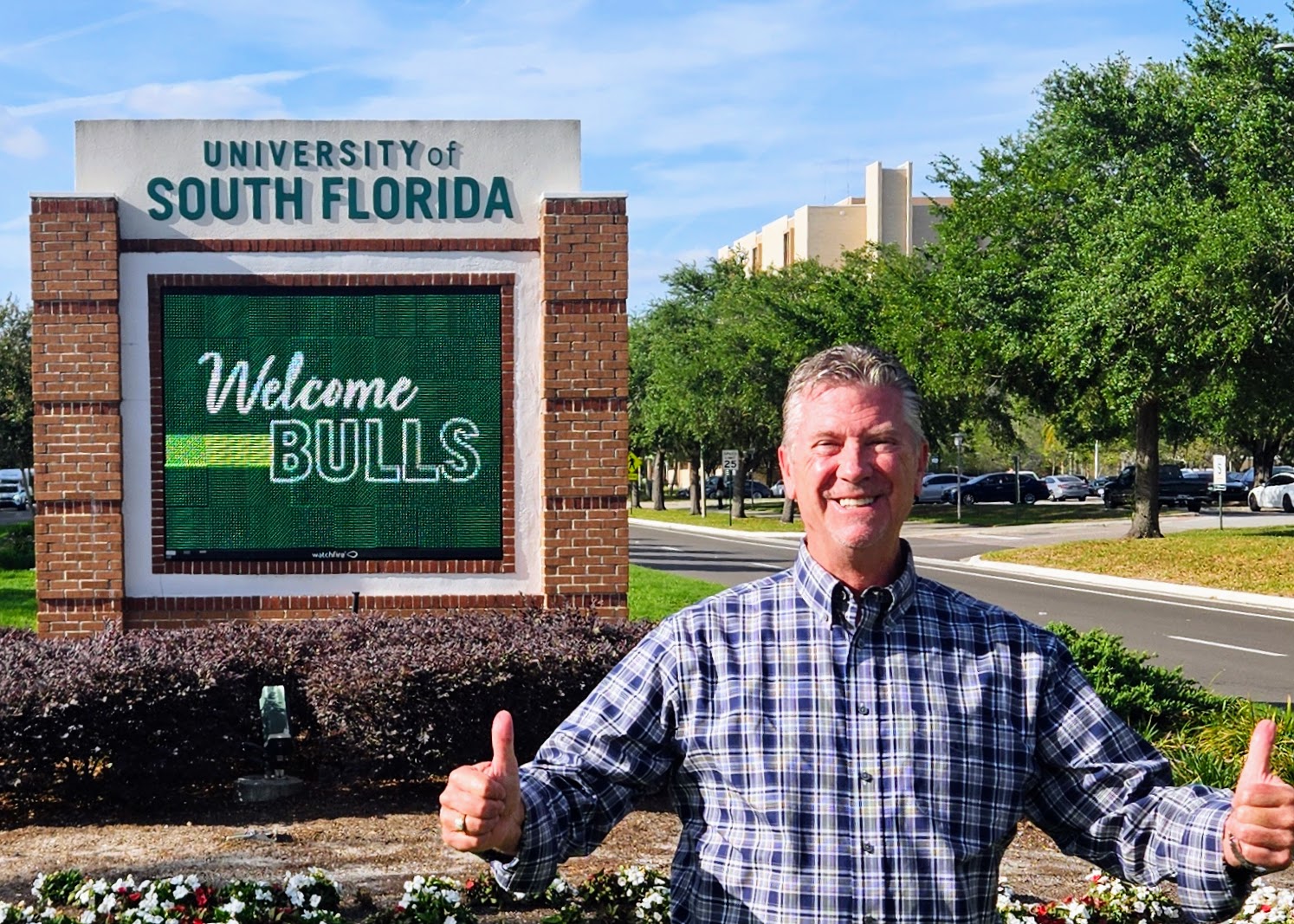 Bob Crews in front of the University of South Florida sign before one of his pre